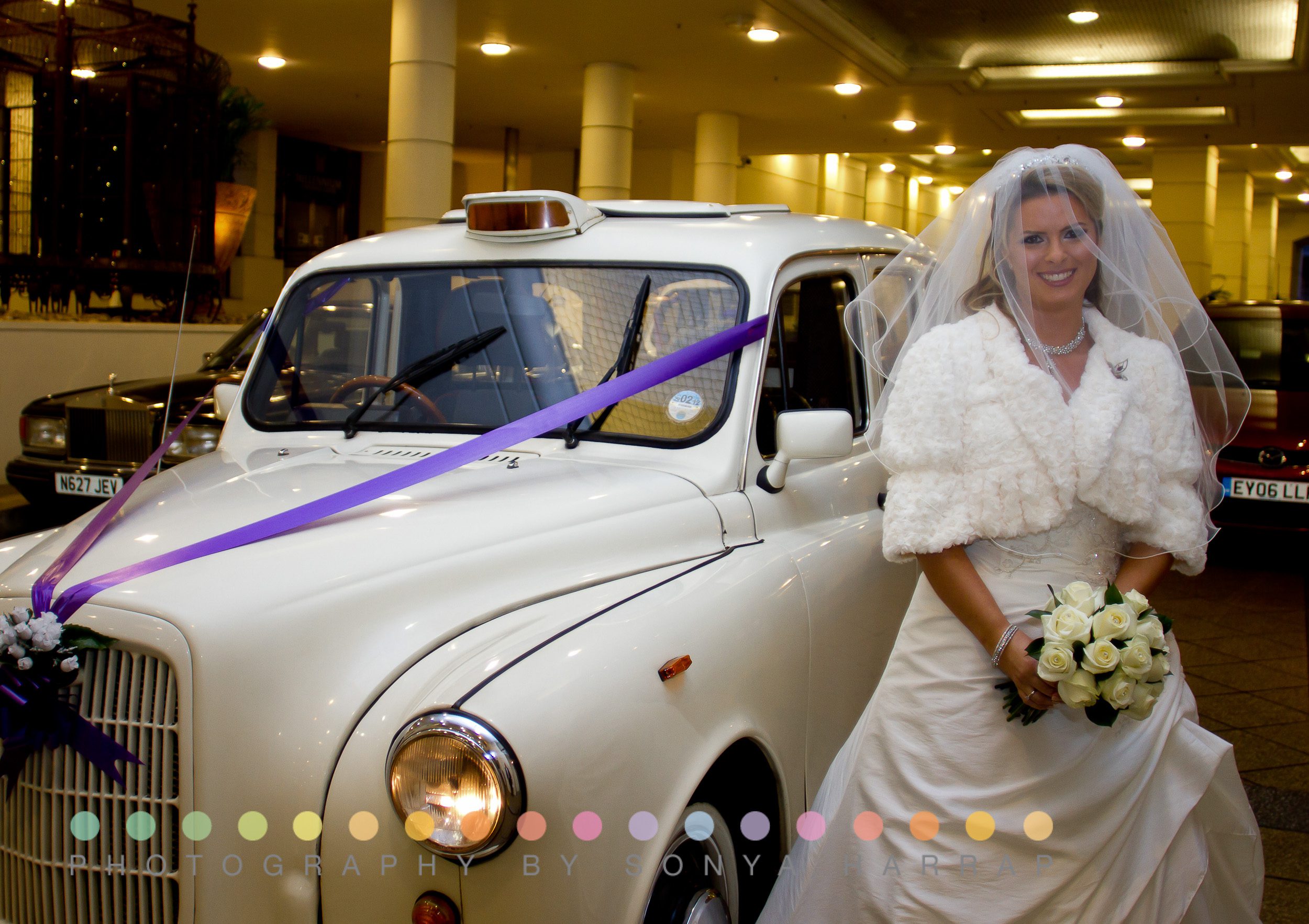 walking to the ceremony bright conservatory western bride a in central London millennium Gloucester hotel wedding standing outside white London taxi
