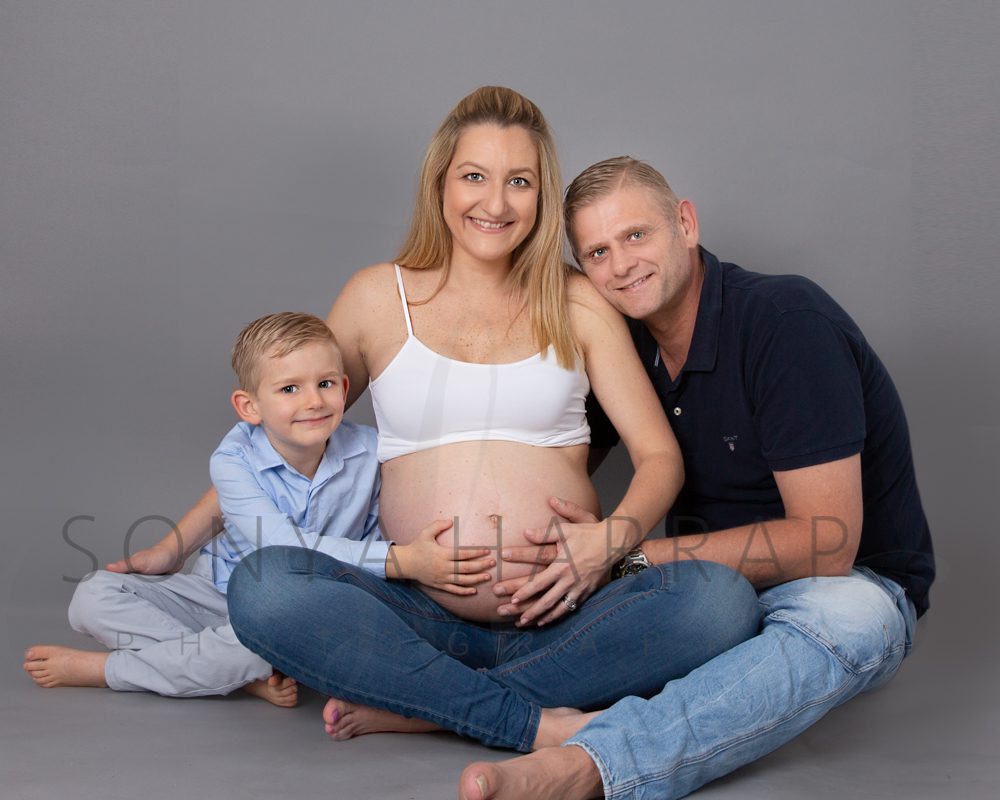 Photograph of mother, son and husband who are expecting a baby. Maternity photoshoot with Sonya Harrap