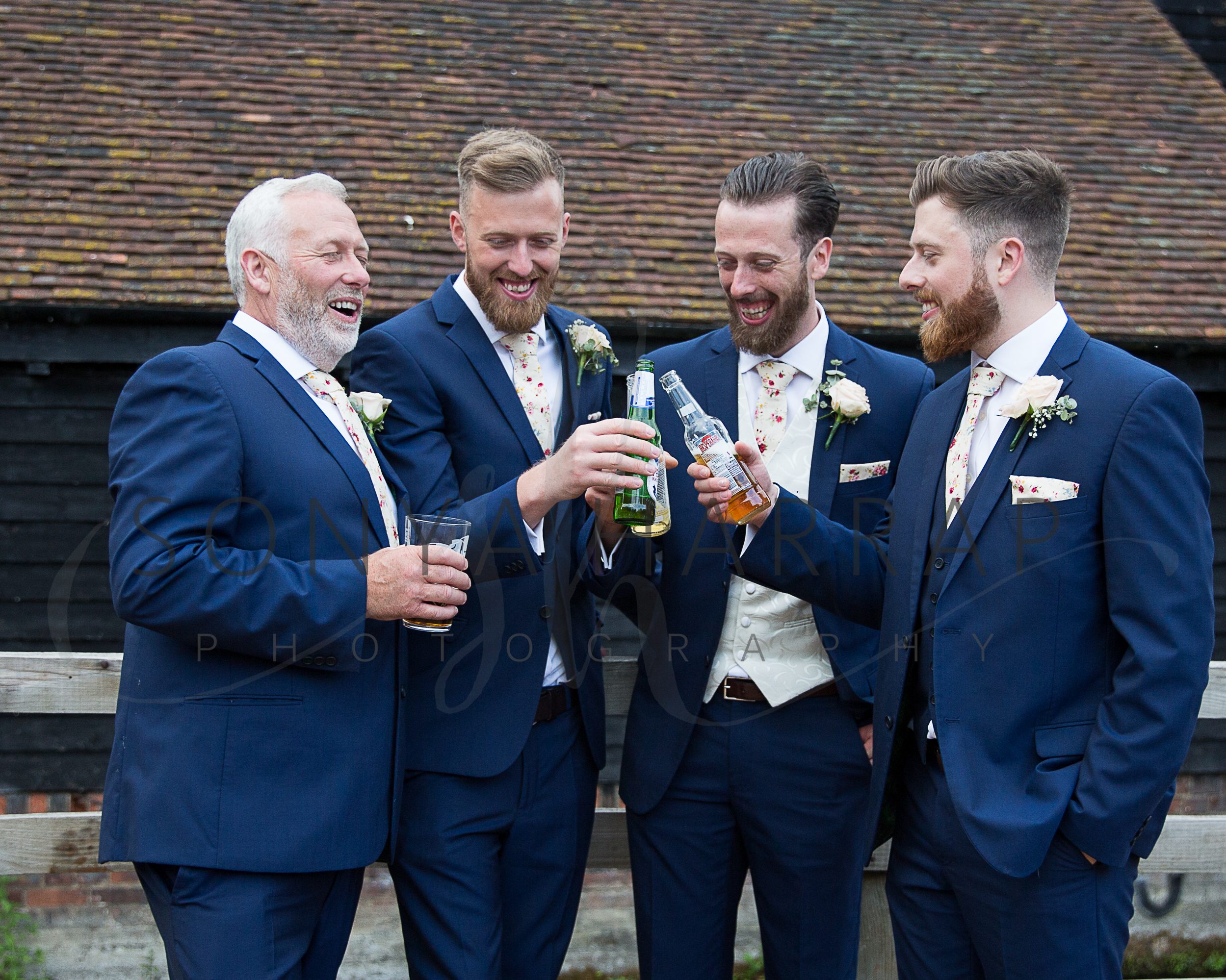 Tewinbury farm hotel wedding photograph of bride and groom by Sonya Harrap photographer four brothers having a pint