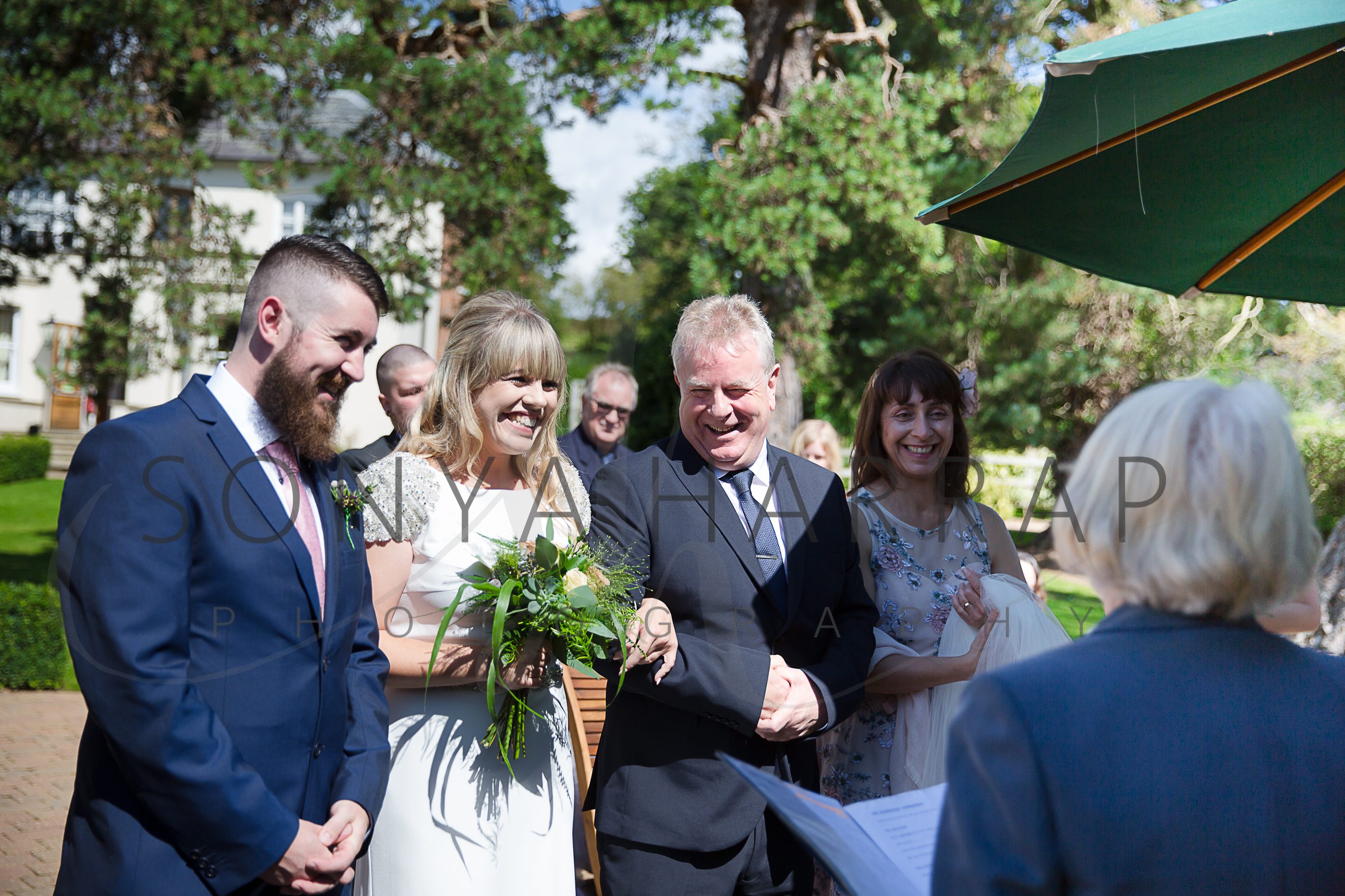 Tewinbury farm hotel hertfordshire wedding photograph of bride and groom outdoor ceremony by Sonya Harrap photographer