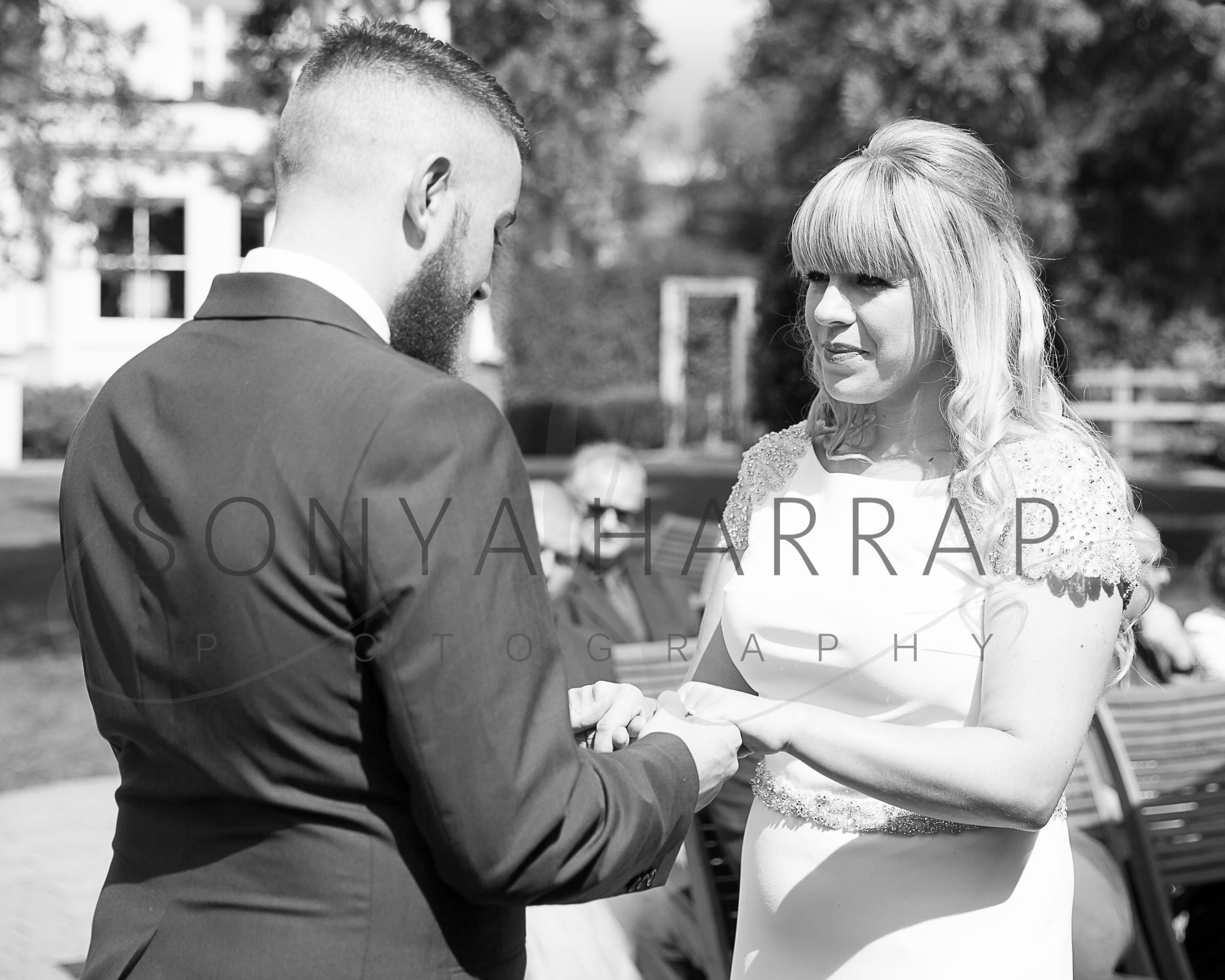 Tewinbury farm hotel hertfordshire wedding photograph of bride and groom outdoor ceremony by Sonya Harrap photographer