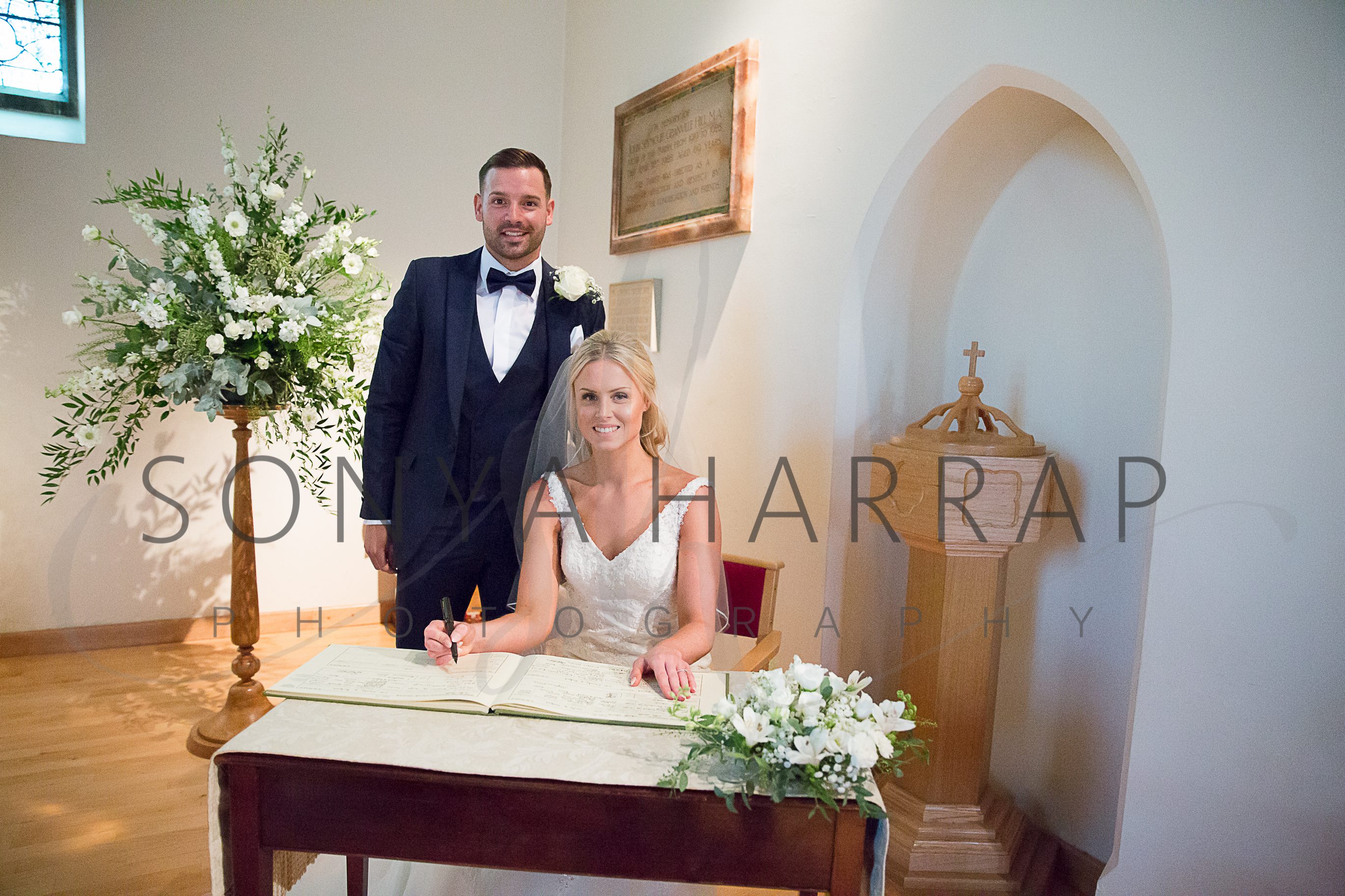 Bride and groom in confetti wedding Photography with white backdrop photography by Sonia Harrap