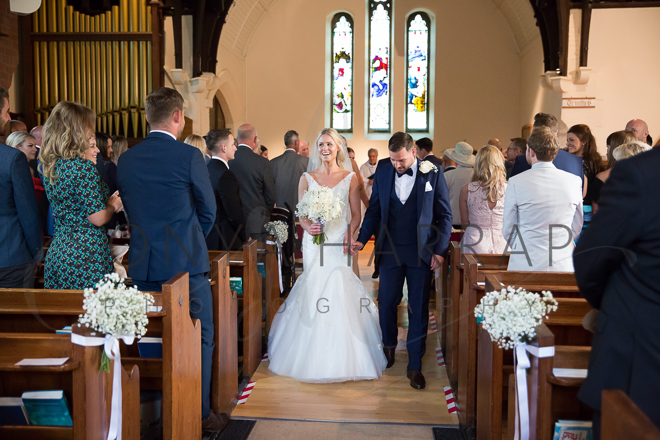 walking down the aisle after being married in Hertfordshire church Photograohy by Sonya Harrap