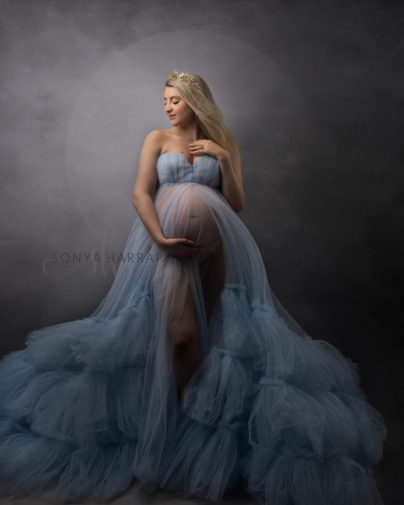 Pregnancy woman in big blue dress for a maternity photoshoot by Sonya Harrap