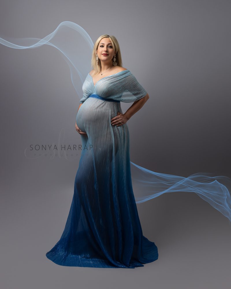 Maternity photoshoot with woman wearing a blue ombre dress
