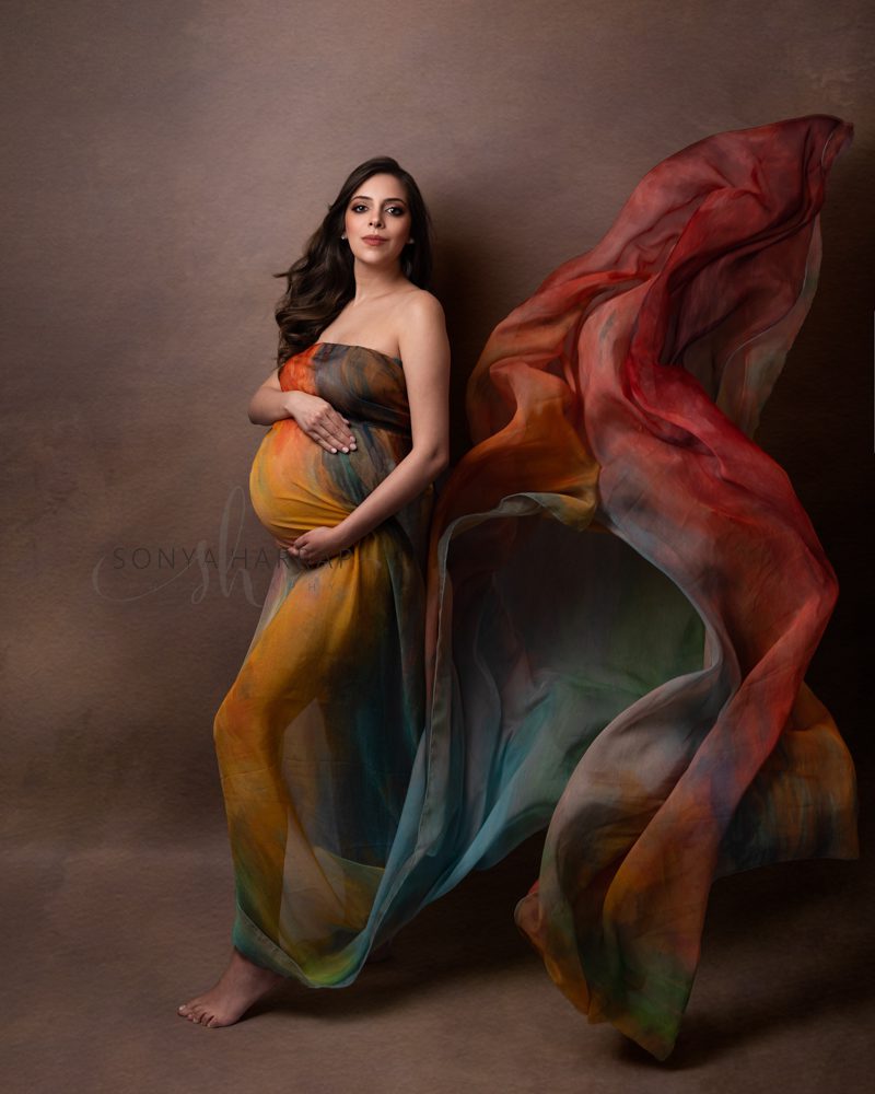 Maternity photo of woman in red fabric