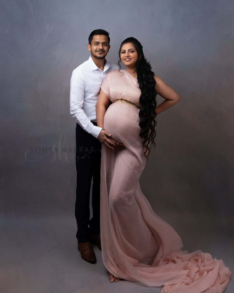 Maternity pregnancy photo of woman in pink with pink flowers couples photos