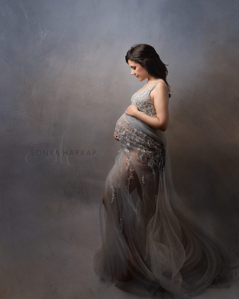 Modest Maternity photoshoot - women holding her bump in silver grey one flowing dress - by Sonya Harrap north London Hertfordshire, st albans, welwyn garden bishops stortford