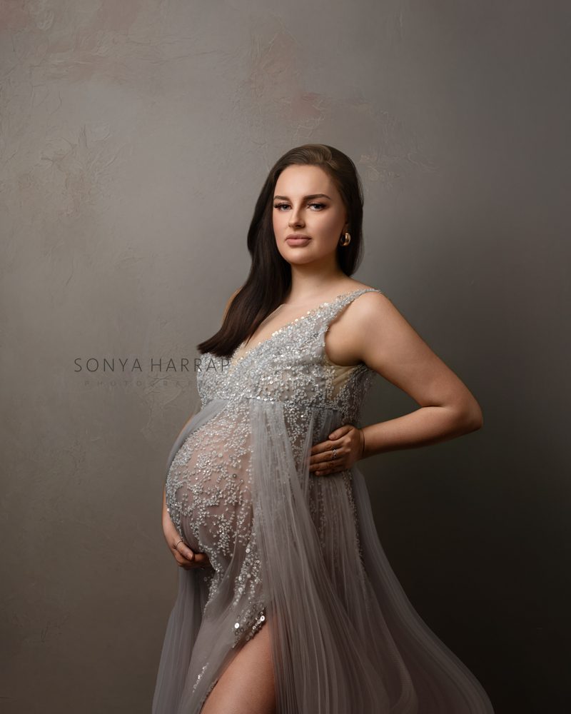modest maternity pregnancy photoshoot by Sonya HARRAP Hertfordshire and London Photographer - woman in green and blue fabric dress brown dress fabric
