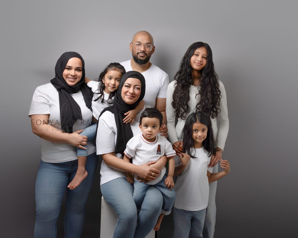 Parents celebrating their baby's first birthday during a family photography session.
